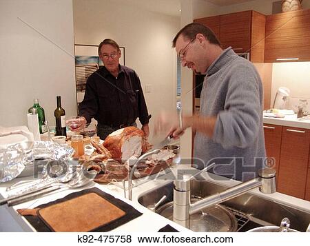Cutting the turkey for Thanksgiving dinner View Large Photo Image Stock Photo - Cutting the turkey for Thanksgiving dinner. Fotosearch