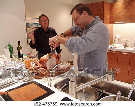 Cutting the turkey for Thanksgiving dinner View Large Photo Image Stock Photo - Cutting the turkey for Thanksgiving dinner. Fotosearch