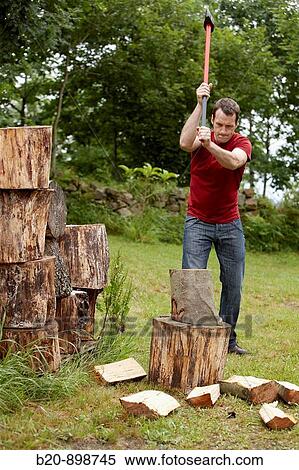 Stock Photography - Cutting wood with splitting axe, hand tool, farming, Guipuzcoa, Basque Country, Spain. Fotosearch