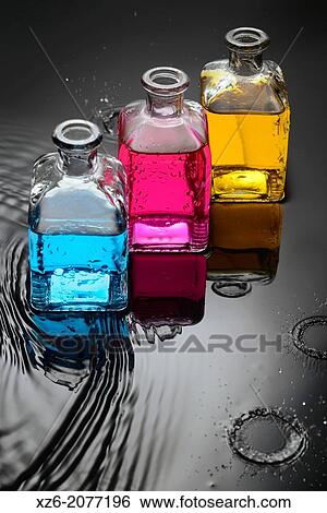 Cyan, magenta, yellow liquids in bottles on water and black background, and a close up of water droplets splashing. View Large Photo Image Stock Photograph - Cyan, magenta, yellow liquids in bottles on water and black background, and a close up of water droplets splashing.. Fotosearch