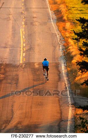 Cycling on country road View Large Photo Image Stock Photo - Cycling on country road. Fotosearch