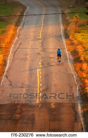 Cycling on country road View Large Photo Image Stock Photograph - Cycling on country road. Fotosearch