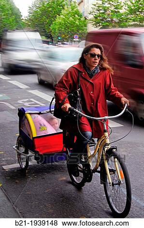 Cycling with a small kid on the back, in the heavy morning traffic at Bordeaux, Gironde, Aquitaine, France View Large Photo Image Stock Photo - Cycling with a small kid on the back, in the heavy morning traffic at Bordeaux, Gironde, Aquitaine, France. Fotosearch