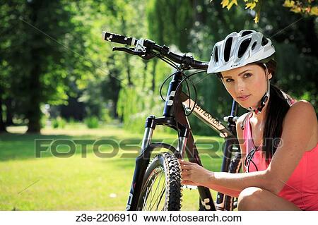 cycling woman taking a break in the park. View Large Photo Image Stock Image - cycling woman taking a break in the park.. Fotosearch