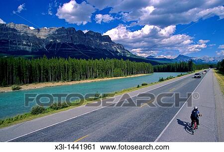 Cyclist along Highway One, Castle Mountain and the Bow River beyond, Alberta, Canada View Large Photo Image Stock Image - Cyclist along Highway One, Castle Mountain and the Bow River beyond, Alberta, Canada. Fotosearch