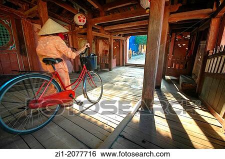 cyclist crossing the famous wooden bridge of Hoi An, Vietnam View Large Photo Image Stock Photograph - cyclist crossing the famous wooden bridge of Hoi An, Vietnam. Fotosearch