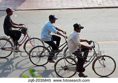 Cyclist on the Riverfront in Kampot, Cambodia. View Large Photo Image Stock Photography - Cyclist on the Riverfront in Kampot, Cambodia.. Fotosearch
