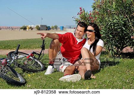 Cyclists lying speaking. View Large Photo Image Stock Photo - Cyclists lying speaking.. Fotosearch