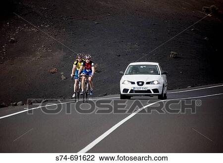 Cyclists on road, Timanfaya National Park, Lanzarote. Canary Islands, Spain View Large Photo Image Stock Image - Cyclists on road, Timanfaya National Park, Lanzarote. Canary Islands, Spain. Fotosearch
