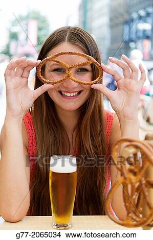 Czech Republic. Prague. Young smiling woman watching through a Pretzel. View Large Photo Image Picture - Czech Republic. Prague. Young smiling woman watching through a Pretzel.. Fotosearch