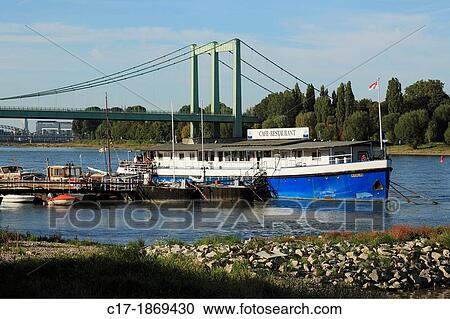 D-Cologne, Rhine, Rhineland, North Rhine-Westphalia, NRW, D-Cologne-Rodenkirchen, gastronomy ship at the Rhine bank, restaurant, cafe, Rhine landscape, Rhine bridge, federal motorway A4 View Large Photo Image Stock Image - D-Cologne, Rhine, Rhineland, North Rhine-Westphalia, NRW, D-Cologne-Rodenkirchen, gastronomy ship at the Rhine bank, restaurant, cafe, Rhine landscape, Rhine bridge, federal motorway A4. Fotosearch
