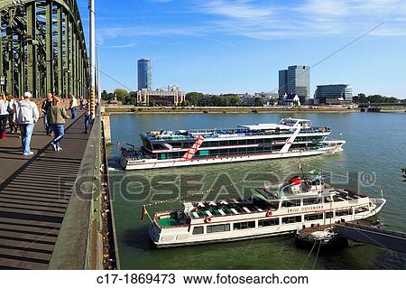 D-Cologne, Rhine, Rhineland, North Rhine-Westphalia, NRW, D-Cologne-Deutz, town view, Rhine promenade, Hohenzollern bridge, high-rise KoelnTriangle, hotel Hayatt Regency, Lufthansa high-rise, excursion ships, tourists View Large Photo Image Stock Image - D-Cologne, Rhine, Rhineland, North Rhine-Westphalia, NRW, D-Cologne-Deutz, town view, Rhine promenade, Hohenzollern bridge, high-rise KoelnTriangle, hotel Hayatt Regency, Lufthansa high-rise, excursion ships, tourists. Fotosearch