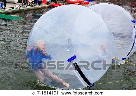 D-Kiel, Kiel Fjord, Baltic Sea, Schleswig-Holstein, Kieler Woche 2011, sailing event, summer fair, Bootshafen, childrens festival, children in large balloon on the water surface View Large Photo Image Stock Image - D-Kiel, Kiel Fjord, Baltic Sea, Schleswig-Holstein, Kieler Woche 2011, sailing event, summer fair, Bootshafen, childrens festival, children in large balloon on the water surface. Fotosearch