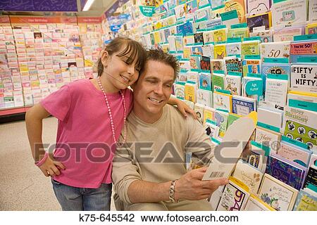 dad and daughter choosing a greeting card View Large Photo Image Stock Image - dad and daughter choosing a greeting card. Fotosearch