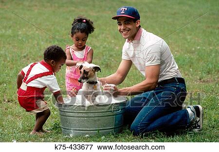 Dad and his children washing dog View Large Photo Image Stock Photo - Dad and his children washing dog. Fotosearch