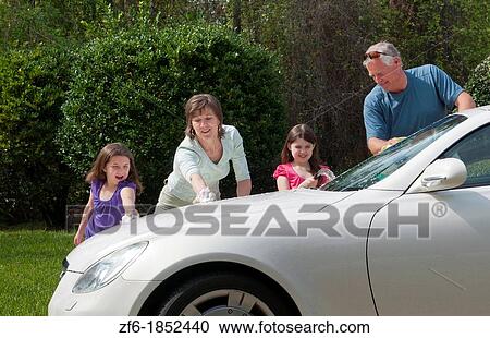 Dad and mom and daughters family washing car at home in driveway together with hose and having fun View Large Photo Image Stock Image - Dad and mom and daughters family washing car at home in driveway together with hose and having fun. Fotosearch