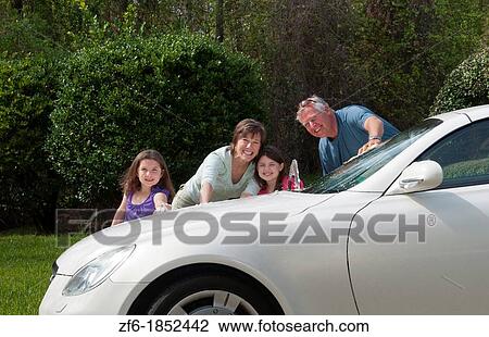 Dad and mom and daughters family washing car at home in driveway together with hose and having fun View Large Photo Image Stock Image - Dad and mom and daughters family washing car at home in driveway together with hose and having fun. Fotosearch