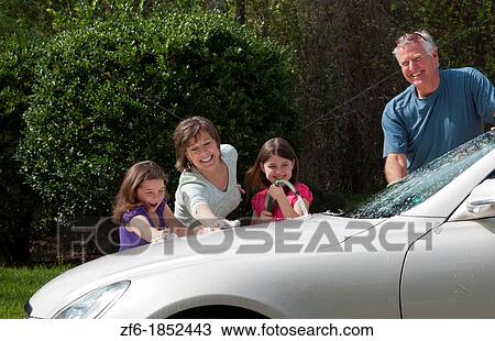 Dad and mom and daughters family washing car at home in driveway together with hose and having fun View Large Photo Image Stock Image - Dad and mom and daughters family washing car at home in driveway together with hose and having fun. Fotosearch