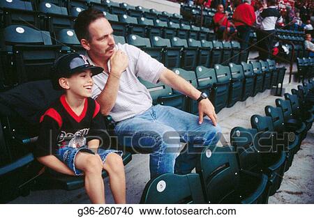 Stock Image - Dad and son watching baseball in Pawtucket. Rhode Island. USA. Fotosearch