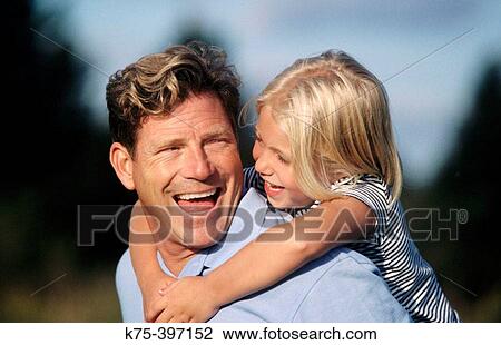 dad carrying his daughter piggyback View Large Photo Image Stock Image - dad carrying his daughter piggyback. Fotosearch
