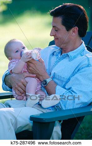 dad feeding his new baby View Large Photo Image Stock Photograph - dad feeding his new baby. Fotosearch