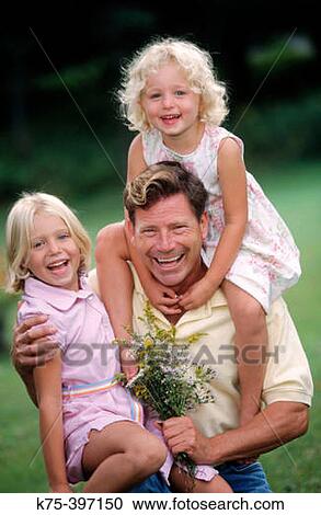 dad holding his two daughters View Large Photo Image Stock Image - dad holding his two daughters. Fotosearch