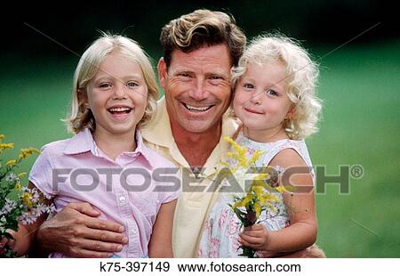 dad hugging two daughters View Large Photo Image Stock Photo - dad hugging two daughters. Fotosearch