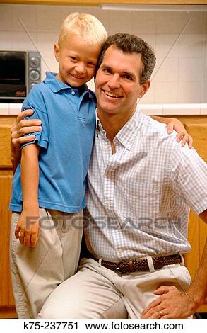 Dad hugs son View Large Photo Image Stock Image - Dad hugs son. Fotosearch