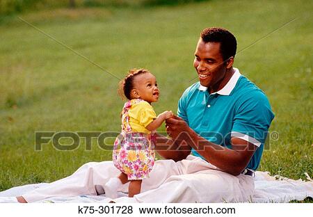 Stock Photo - dad interacting with toddler daughter. Fotosearch
