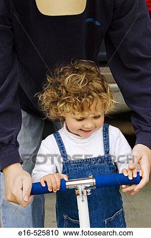 Dad with daughter on skate toy View Large Photo Image Stock Image - Dad with daughter on skate toy. Fotosearch