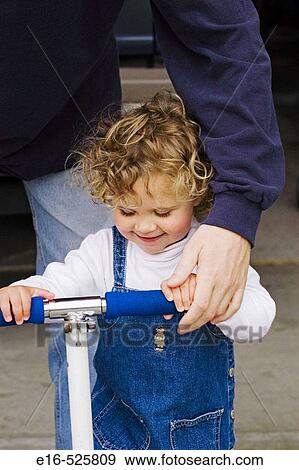 Dad with daughter on skate toy View Large Photo Image Stock Photo - Dad with daughter on skate toy. Fotosearch