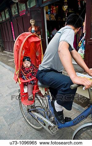 Daddy and his baby on a bicycle in Ping Yao, China. View Large Photo Image Stock Photography - Daddy and his baby on a bicycle in Ping Yao, China.. Fotosearch