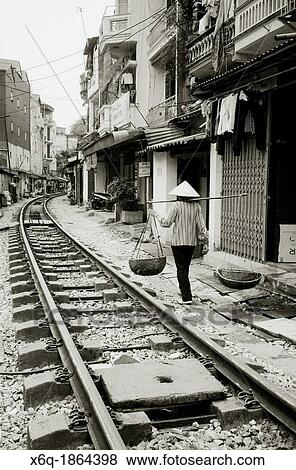 Stock Photo - Daily life by the train tracks in Hanoi in Vietnam. Fotosearch