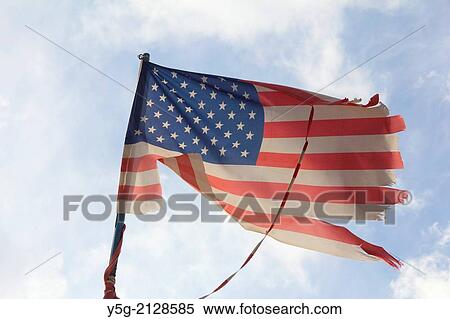 damaged american flag flying in the wind View Large Photo Image Stock Photography - damaged american flag flying in the wind. Fotosearch