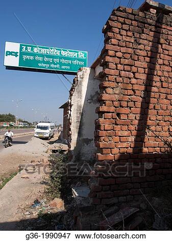 Damaged brick walls and information sign in a building removed to make way for upcoming highway in Fatephur Sikri, Uttar Pradesh, India. View Large Photo Image Stock Photo - Damaged brick walls and information sign in a building removed to make way for upcoming highway in Fatephur Sikri, Uttar Pradesh, India.. Fotosearch