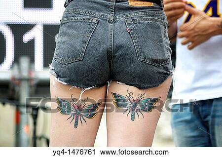 Stock Image - Dancer with butterfly tattoos on their thighs, Gay Pride Day 2011, Madrid, Spain. Fotosearch
