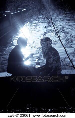 Dark silhouettes of a couple by the lake View Large Photo Image Stock Image - Dark silhouettes of a couple by the lake. Fotosearch