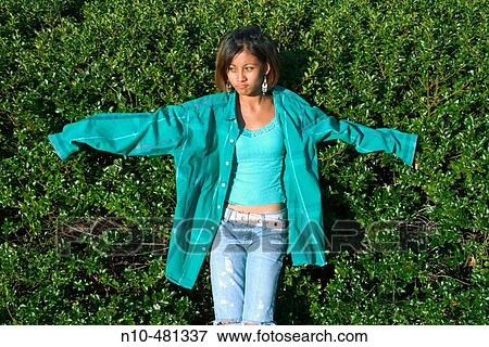 Dark skin teen girl, at a park, with her arms outstretched View Large Photo Image Stock Photo - Dark skin teen girl, at a park, with her arms outstretched. Fotosearch