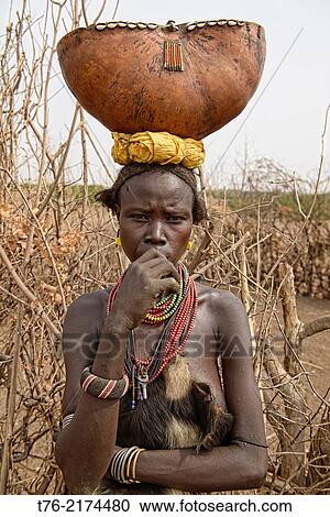 Dassanech woman with a gourd on her head, Lower Omo Valley of Ethiopia. View Large Photo Image Stock Image - Dassanech woman with a gourd on her head, Lower Omo Valley of Ethiopia.. Fotosearch