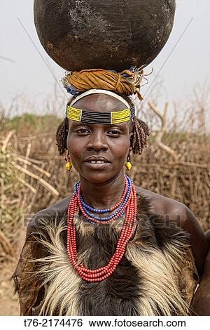Dassanech woman with a gourd on her head, Lower Omo Valley of Ethiopia. View Large Photo Image Stock Photograph - Dassanech woman with a gourd on her head, Lower Omo Valley of Ethiopia.. Fotosearch