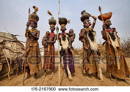 Dassanech women with hyena pelt skins and jugs on their heads in the Lower Omo Valley of Ethiopia. View Large Photo Image Stock Image - Dassanech women with hyena pelt skins and jugs on their heads in the Lower Omo Valley of Ethiopia.. Fotosearch