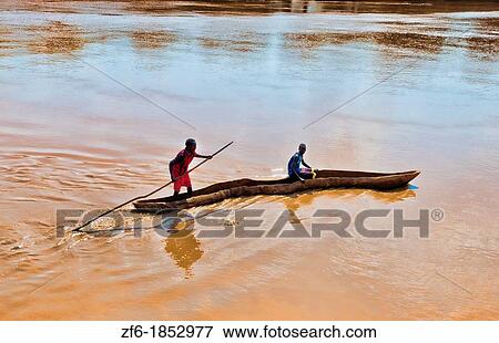 Dassnech Tribe in Omorate Ethiopia Africa Lower Omo Valley muddy water with dug out camoe to cross river View Large Photo Image Stock Photo - Dassnech Tribe in Omorate Ethiopia Africa Lower Omo Valley muddy water with dug out camoe to cross river. Fotosearch