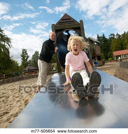 Picture - Daughter and father playing in playground. Danmark. Fotosearch