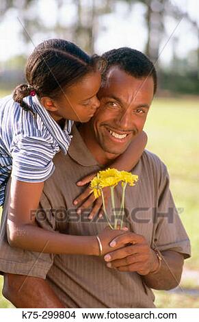 Daughter gives dad a flower View Large Photo Image Picture - Daughter gives dad a flower. Fotosearch