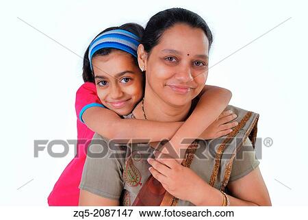 Stock Photo - Daughter hugging her mother, Pune, India.. Fotosearch