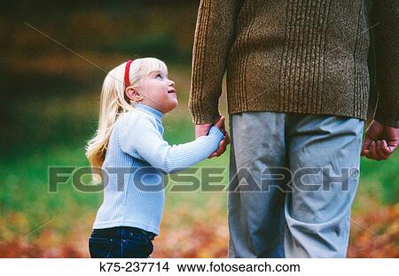 Daughter looks up to dad View Large Photo Image Picture - Daughter looks up to dad. Fotosearch