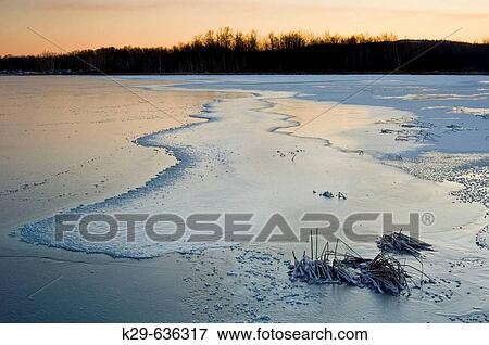 Dawn skies reflected in fresh ice of frozen bay in Kelly Lake View Large Photo Image Stock Photo - Dawn skies reflected in fresh ice of frozen bay in Kelly Lake. Fotosearch