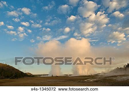 Stock Image - Daybreak illuminates the geyser clouds above Grand Prismatic geyser in Yellowstone. Fotosearch