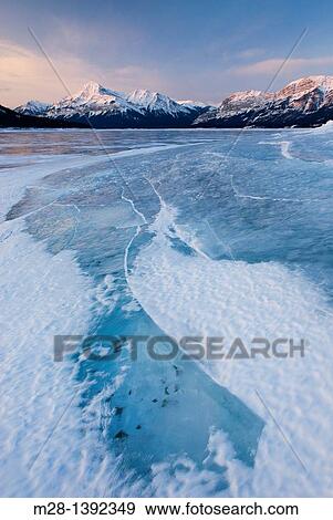 Stock Photo - Daybreak over the wind blasted surface of Abraham Lake, Alberta Canada. Fotosearch