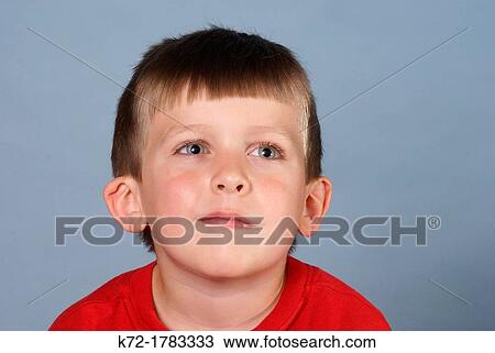 Daydreaming boy looks off into space View Large Photo Image Stock Image - Daydreaming boy looks off into space. Fotosearch